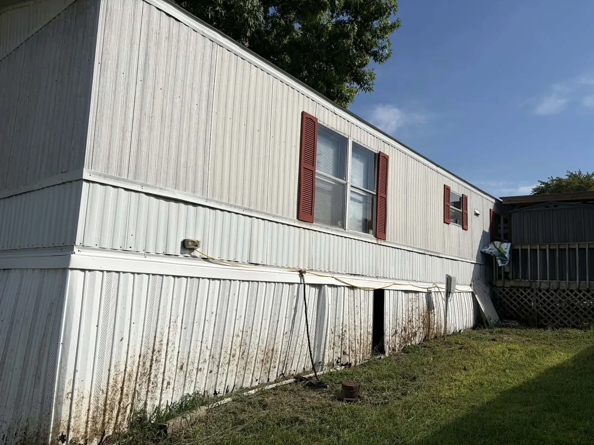 Damaged mobile home skirting before repair